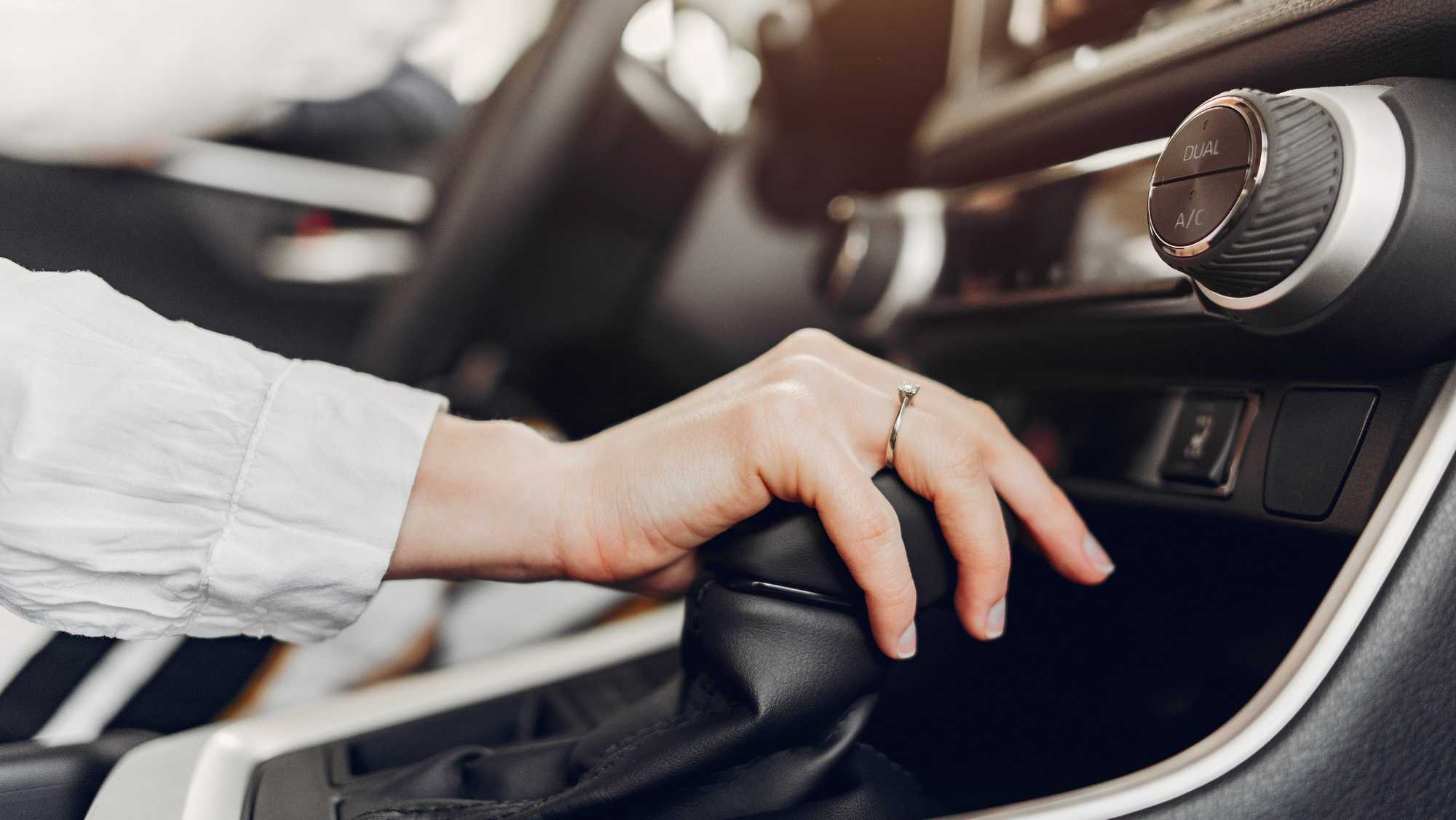 Car dashboard showing automatic vs manual transmission comparison