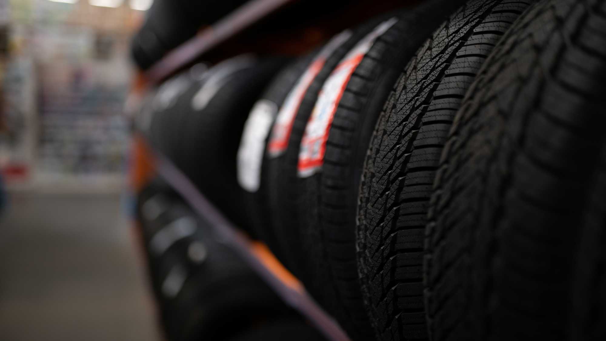 Auto repair technician inspecting vehicle at Jim Whaley Tires in Eufaula