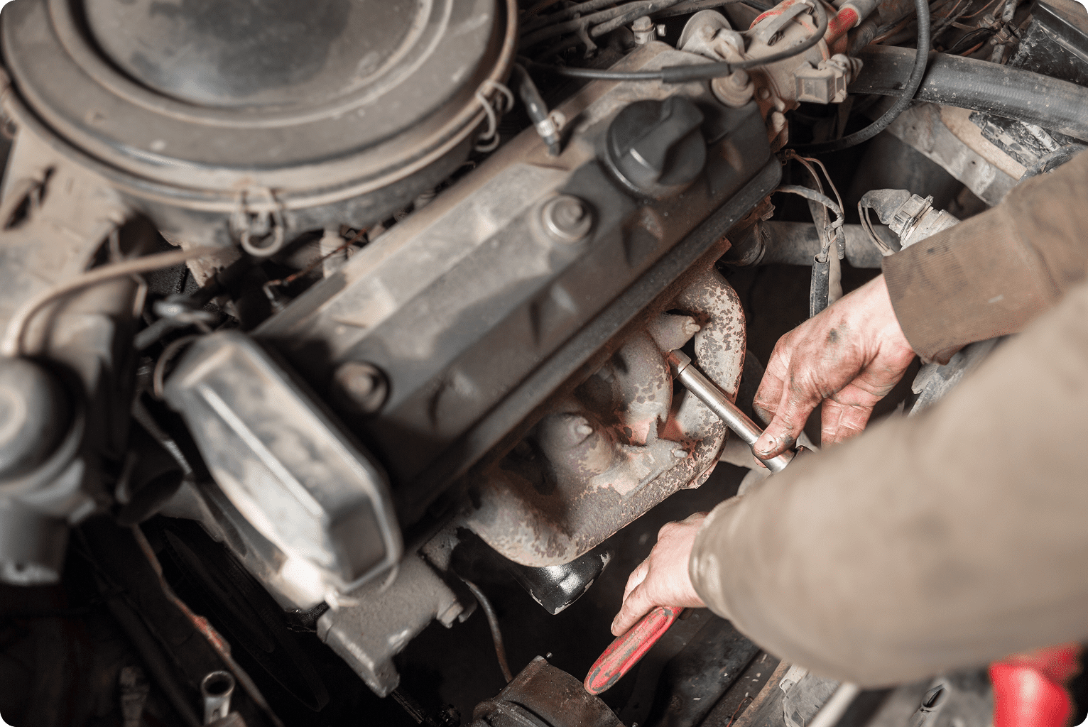 hands of repairman mechanic working on engine
