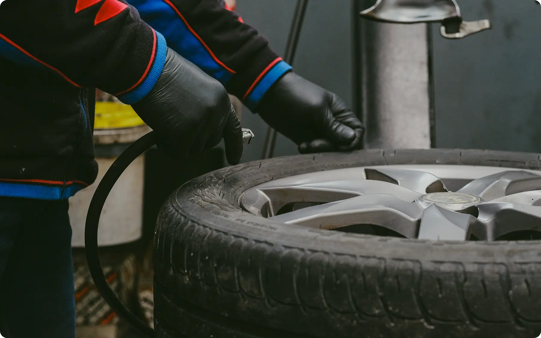 mechanic with black rubber gloves preparing to rem