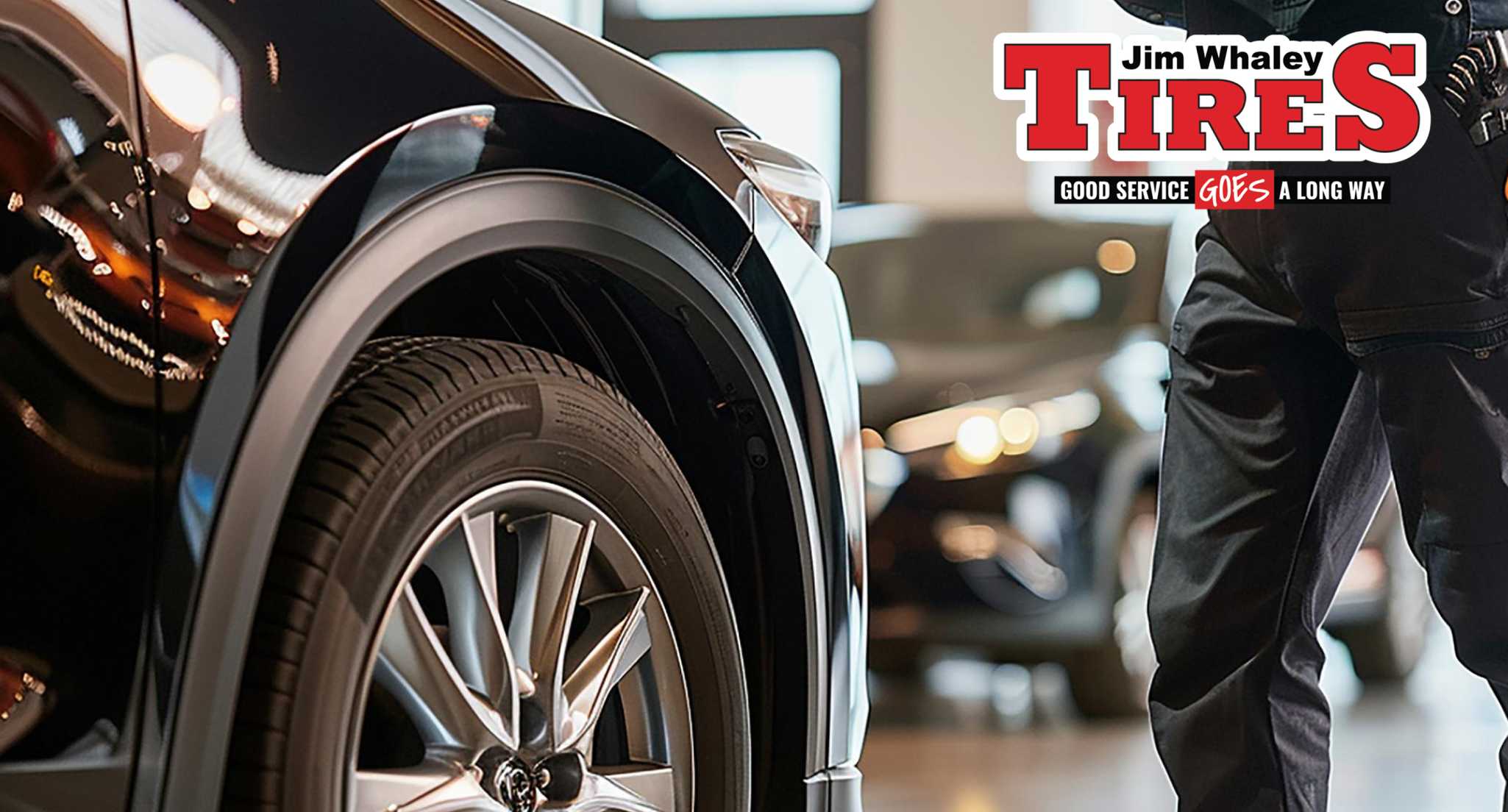 Technician inspecting tire wear patterns on vehicle in Dothan shop
