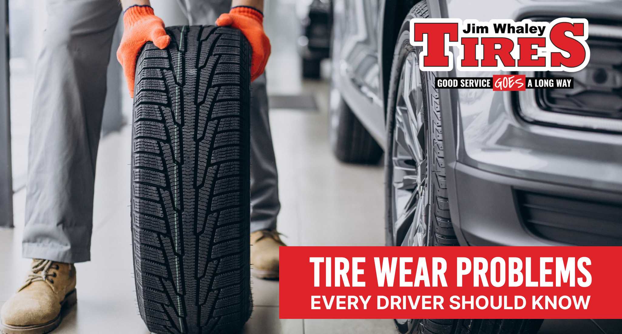 Tire technician inspecting uneven tire wear at Jim Whaley Tires in Dothan AL