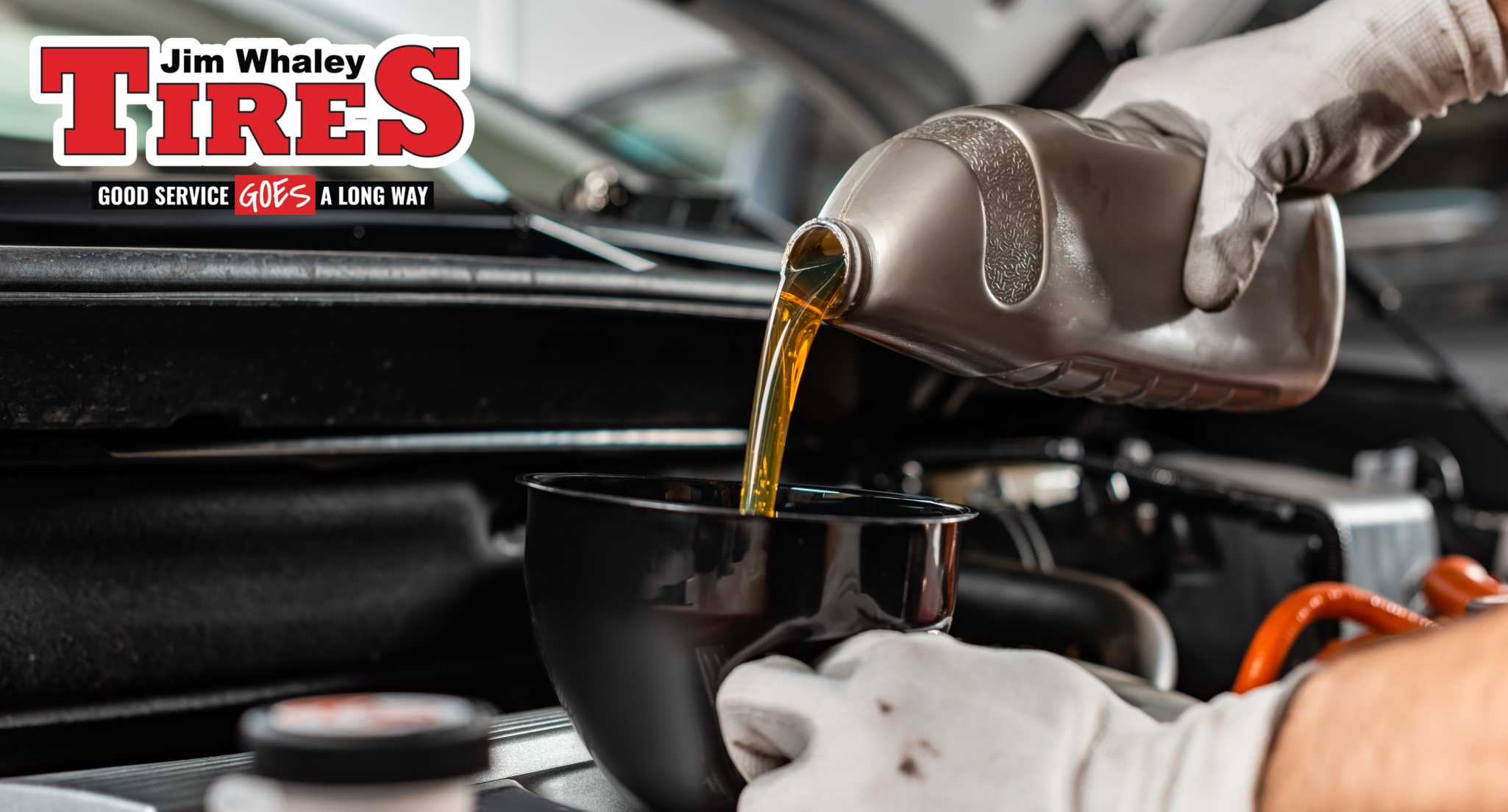 Mechanic performing oil change at service bay in Enterprise Alabama