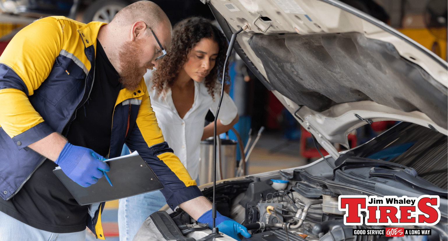 Mechanic performing vehicle maintenance before Marianna FL road trips at Jim Whaley